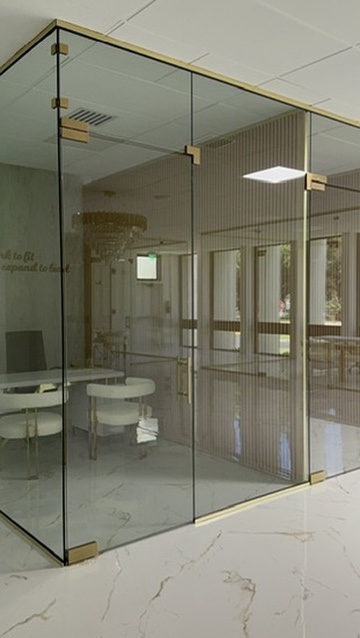 Glass office enclosure with gold hardware