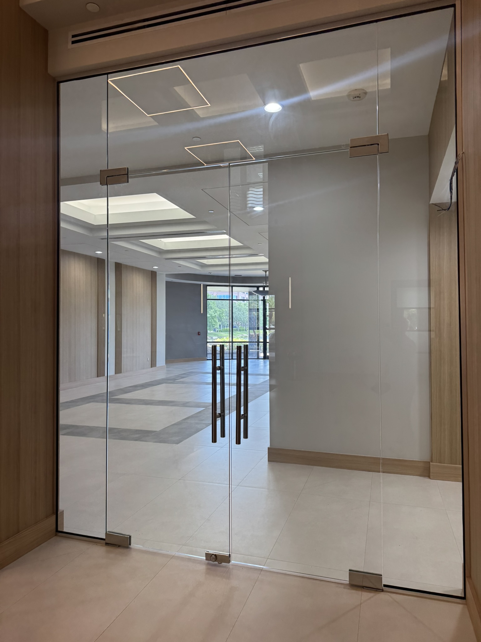 Frameless glass entry doors in commercial lobby