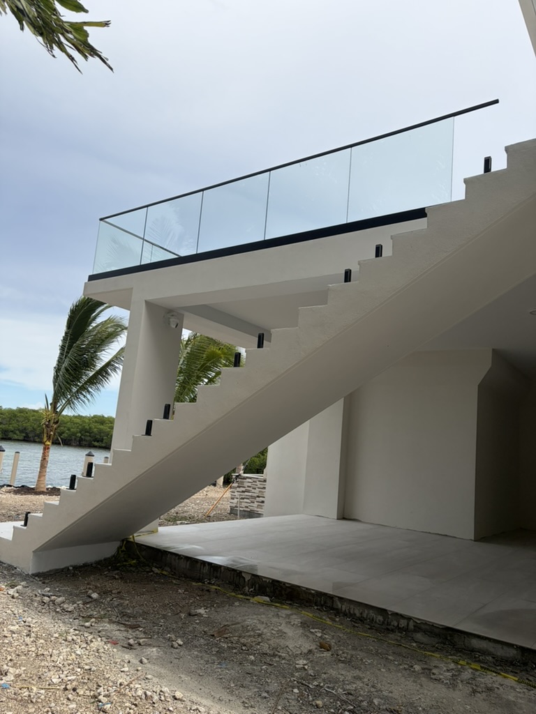 Exterior glass balcony and stair railing by the water