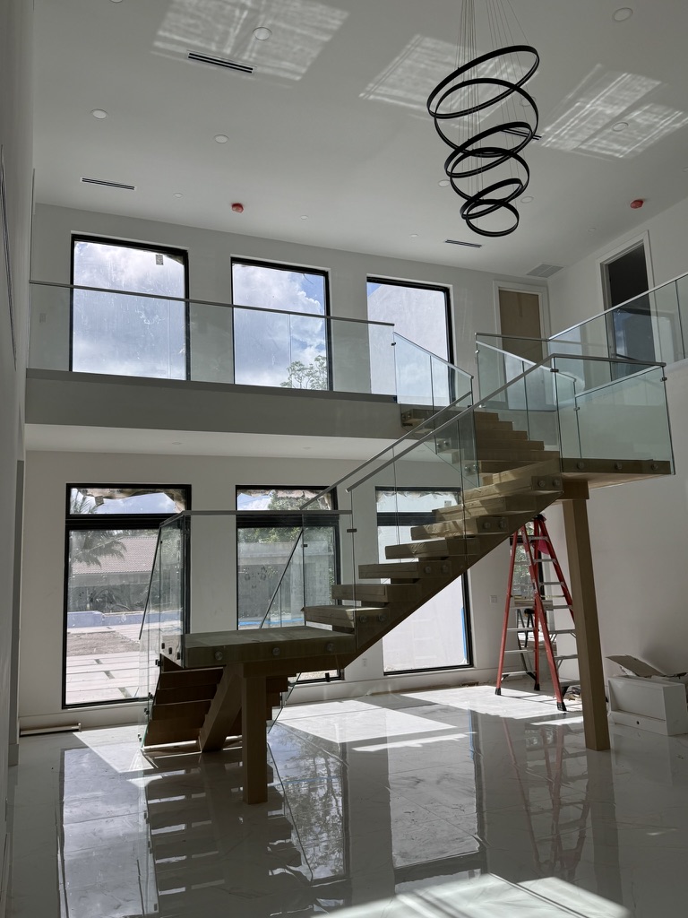 Glass stair railing with top rail in modern home