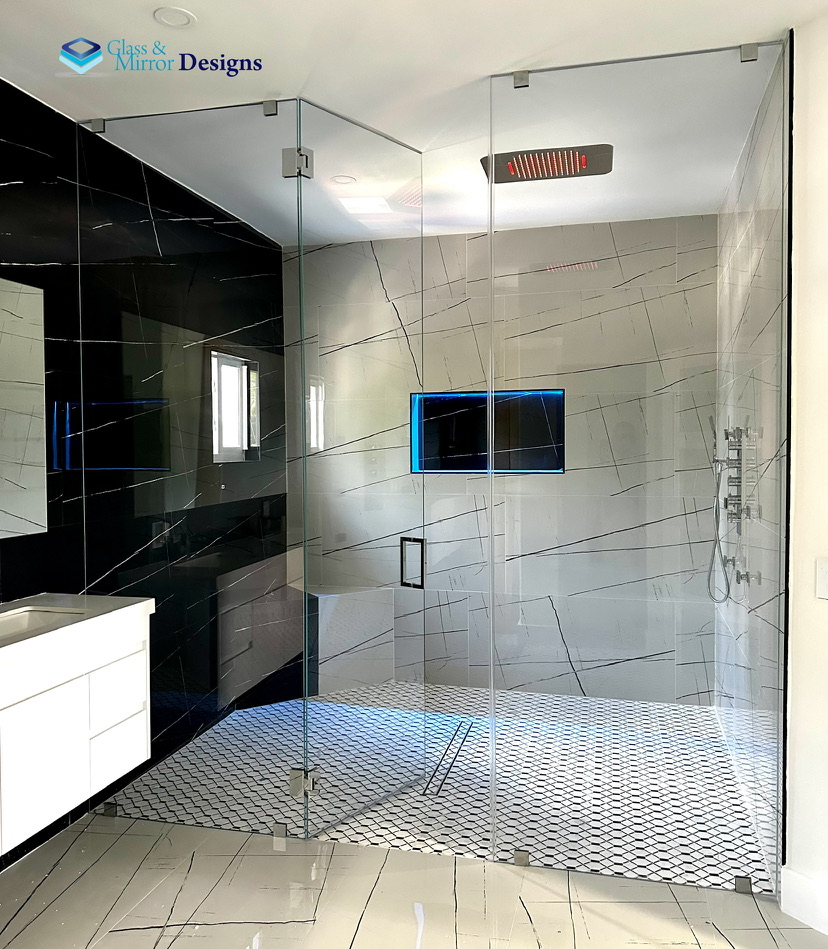 Frameless corner shower enclosure with black marble wall
