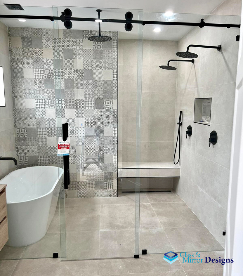 Sliding barn-style shower door with matte black hardware