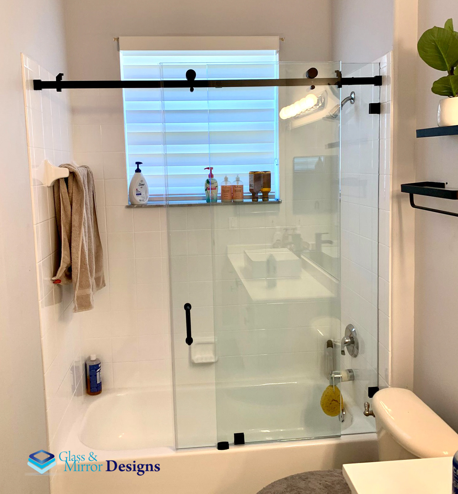 Sliding tub shower door with matte black hardware