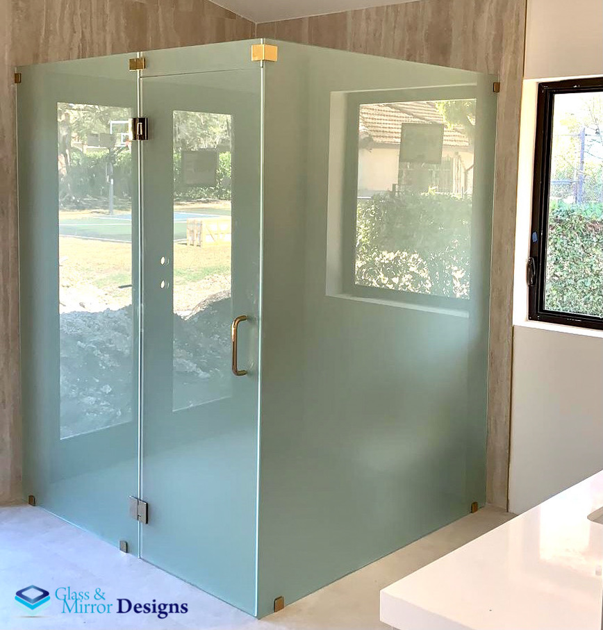 Frameless corner shower enclosure with chrome hardware
