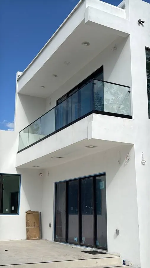 Glass balcony railing on black base shoe