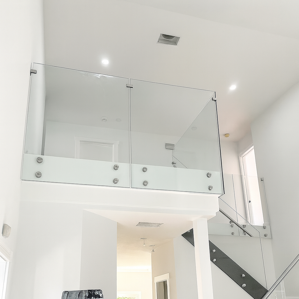 Modern frameless glass railing system featuring polished chrome standoffs for a clean, high-end architectural look. Modern frameless glass railing system featuring polished chrome standoffs for a clean, high-end architectural look.