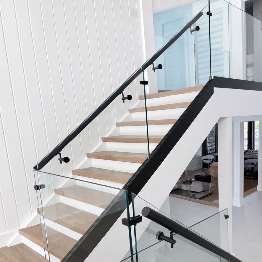Minimalist glass railing system for modern staircases. Minimalist glass railing system for modern staircases.